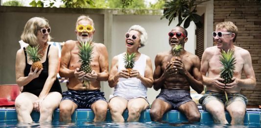 Image of happy seniors sitting poolside looking healthy and alert thanks to techniques to improve memory and brain health