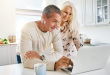 Image of senior couple using a laptop to over over 50s home insurance online