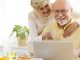 Image of a happy senior couple using a laptop to go online thanks to installing a wifi signal booster to extend wifi range