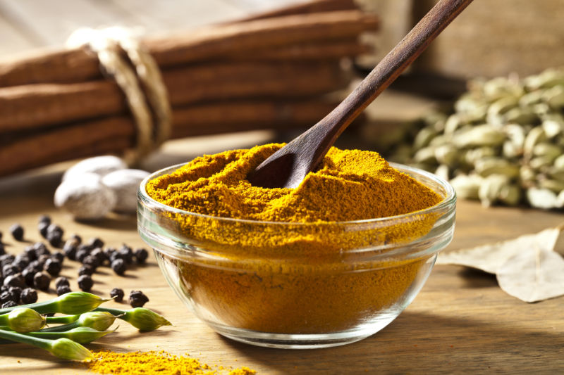 Winter wellness tips: Curry Powder in a Bowl on Wooden Table