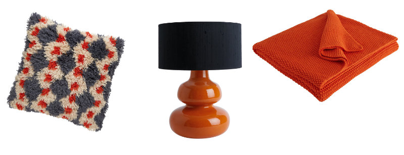 (L-R) Casper Charcoal & Orange Geometric Shaggy Pile Cushion, currently reduced to £35 from £70; Lantana Orange Curvy Lamp With Black Drum Silk Shade, £115, Habitat (Habitat/PA)