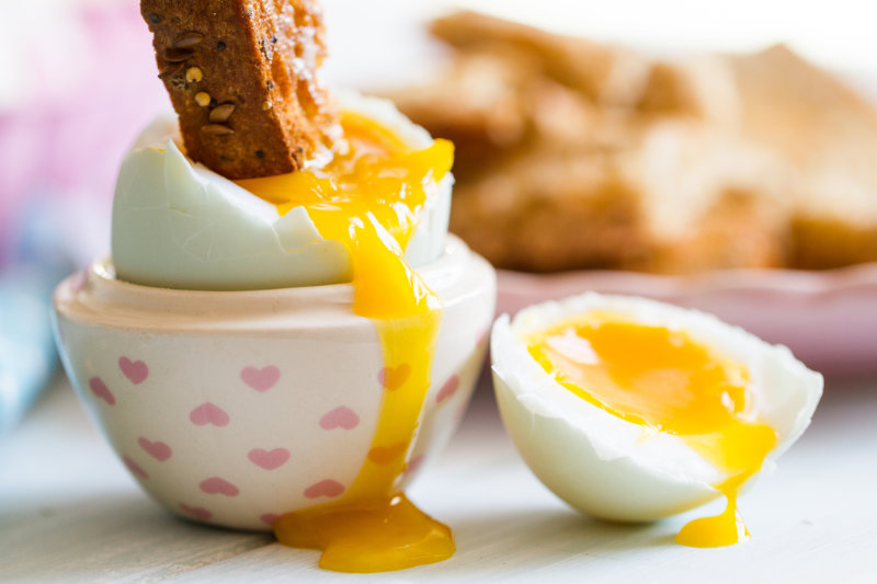 How much vitamin d is in one egg – opened egg with soft yolk with toast