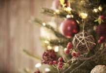Live Christmas Tree with Eco Friendly Decorations, Ornaments and Gifts on an Old Wood Background