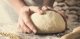 Man baking bread to increase happiness and wellbeing