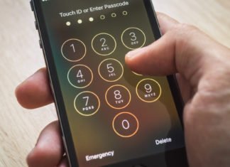 Photo of passwords on iPhone with thumb tapping in passcode