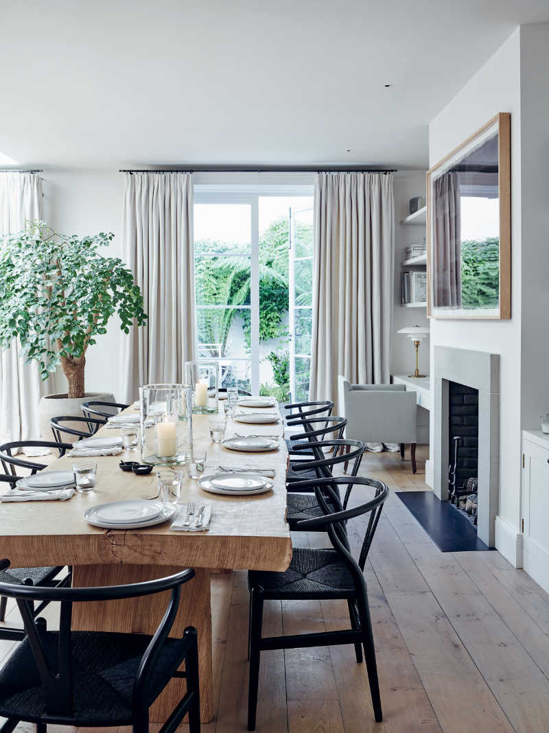A dining area in Chrissie Rucker’s open plan kitchen, which features in her new book, For The Love Of White : The White & Neutral Home. Black Wishbone chairs, by Hans Wegner, set around a custom made oak table, add weight to the neutral colour scheme. (Chris Everard/For The Love Of White/PA)