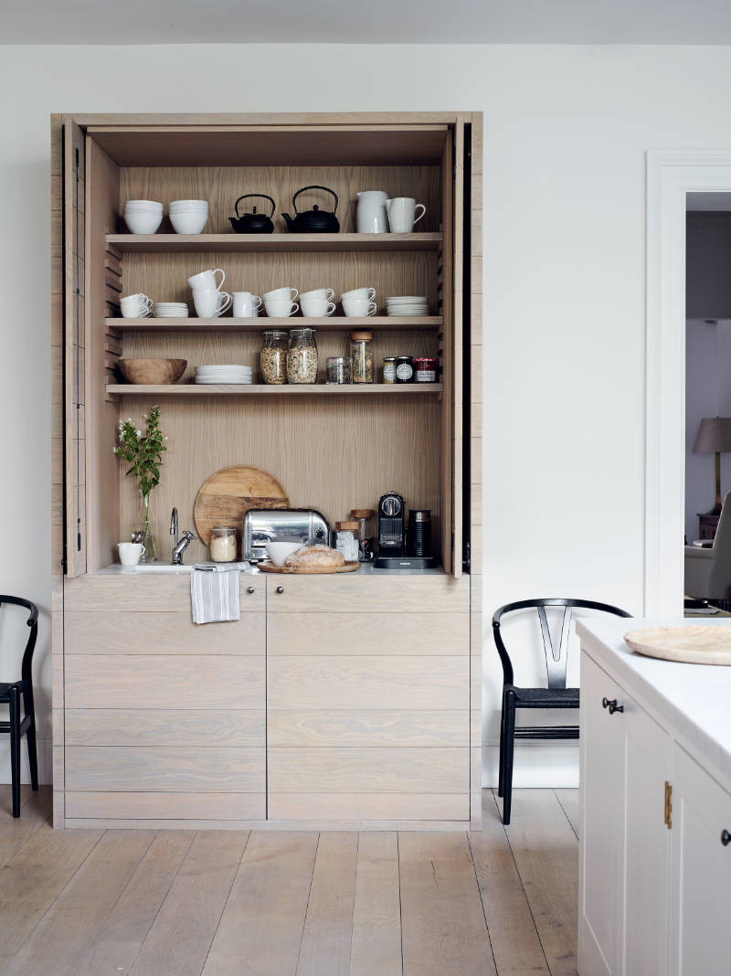 A custom-made breakfast unit is one of Chrissie’s favourite features in her kitchen The doors slide back into the recess to reveal everything from a toaster, a coffee maker, cups and bowls and an integrated hot water tap. (Chris Everard/For The Love of White/PA)