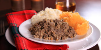 Burns night Scottish Haggis Serving For A Traditional Rabbie Burns Night Dinner With Neeps And Tatties A Glass Of Scotch Whiskey, Against A Royal Stuart Tartan Napkin