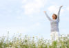 Non-HRT menopause treatment Woman with stretched arms in flower field