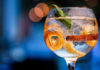 gin on bar counter with blurred background in shades of blue.
