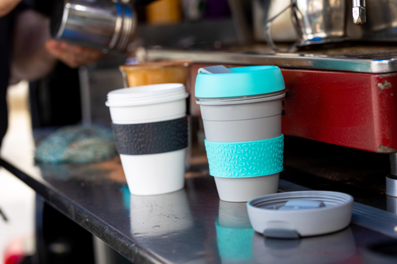 Barista At Mobile Coffee Van Using Reusable Coffee Cups