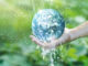 Save water save money Water pouring on planet earth placed on human hand for saving resources and heal the world campaign, environment issues, Elements of this image furnished by NASA.