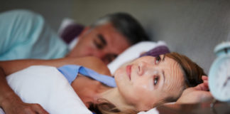 Couple In Bed With Wife Suffering From Insomnia Late At Night