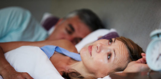 Couple In Bed With Wife Suffering From Insomnia Late At Night