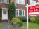 Sell your home fast For sale sign outside a house in an affluent suburb of London