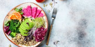 Healthy food weight loss Vegan, detox Buddha bowl with quinoa, micro greens, avocado, blood orange, broccoli, watermelon radish, alfalfa seed sprouts.