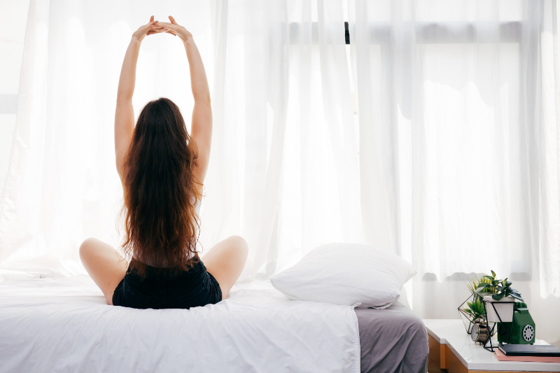 Woman stretching on a bed