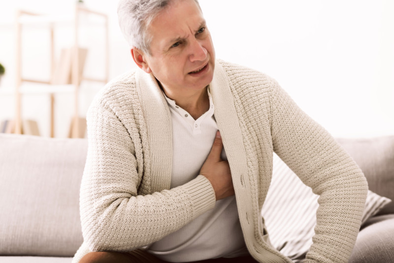 Too much caffeine Mature man with chest pain, suffering from heart attack at home