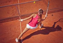Health benefits of tennis Female tennis player hitting a ball with forehand volley