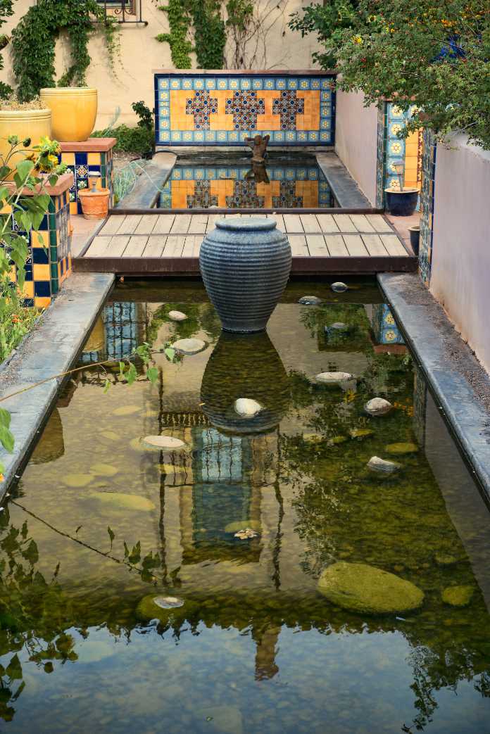 Nicely landscaped courtyard area, with pots, tile and reflecting pond