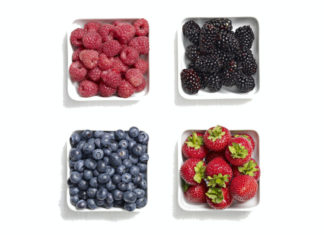 Four white bowls containing strawberries, blueberries, raspberries and blackberries (British Summer Fruits/PA)