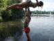 Couple recreating the Dirty Dancing lift in a lake