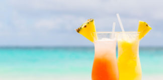 Two tropical cocktails on white sandy beach (iStock/PA)