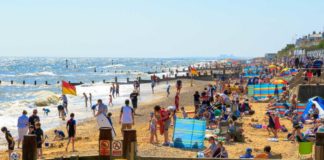 Southwold, UK – August 17, 2016 – People sunbathing and playing at Southwold beach.