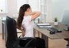 Poor posture – Young Businesswoman Sitting On Chair Having Backpain In Office