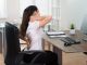 Poor posture – Young Businesswoman Sitting On Chair Having Backpain In Office
