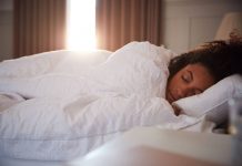 Woman asleep under weighted blanket