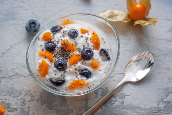 yogurt in a glass bowl with blueberries and physalis 