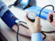 Doctor measuring blood pressure of patient
