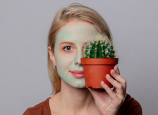 Cactus beauty products beautiful blond girl with green mask and cactus