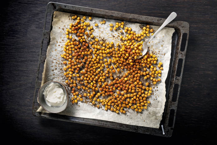Tray of baked or roasted chick-peas seasoned with paprika and oregano.