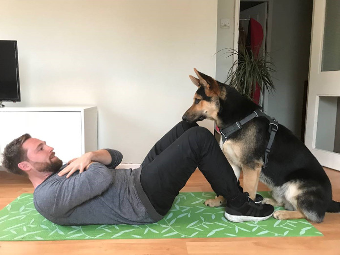Exercising with your dog doing sit ups