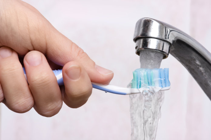 Wash your toothbrush under running water to help keep it clean