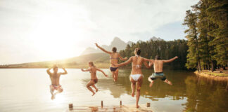 Holiday advice Friends leaping into a lake