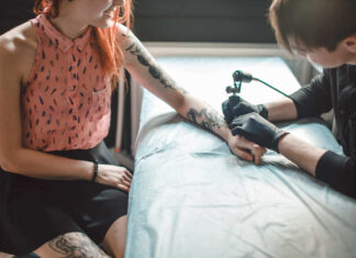 A tattoo artist creating a tattoo