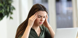 A women suffering from a migraine due to lack of omega-3