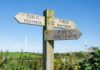 A signpost for public footpaths, causing erosion