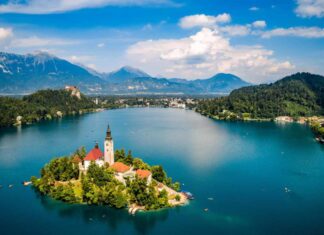 A small island with a house and tall tower in Slovenia