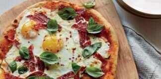 Breakfast for dinner pizza with eggs, courgette and spicy salami