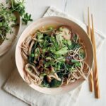 Miso noodle soup with mushrooms, peas and greens