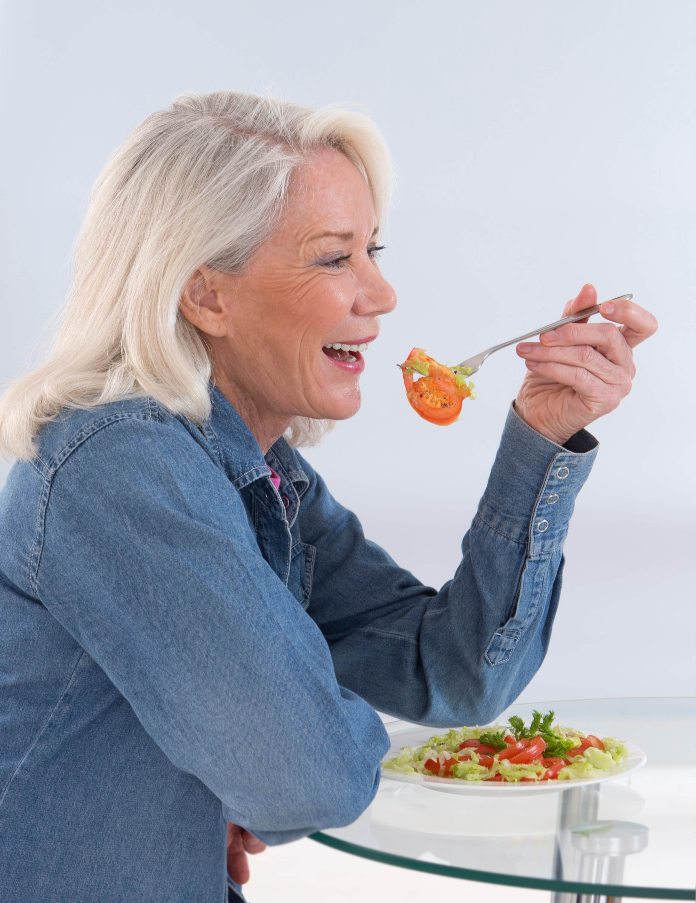 Woman eating vegetables