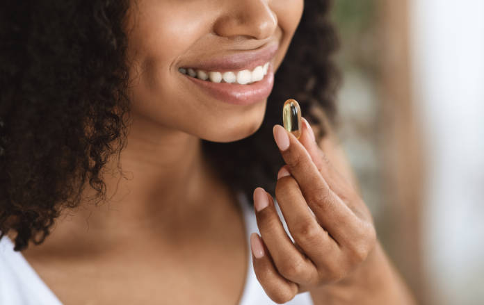Woman taking a prebiotic supplement