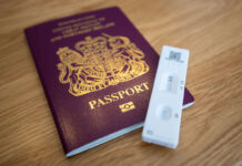 A British passport with a lateral flow test
