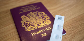 A British passport with a lateral flow test