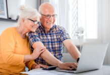 couple checking retirement plans on laptop