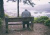 Sad and lonely man sitting on a bench